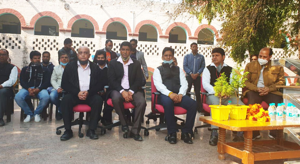 Community members seated in front of the school building during the documented event